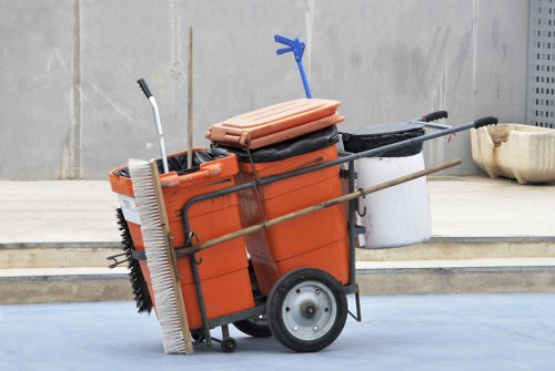 Workers handling bins with gloves and high-visibility vests