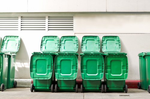 Workers safely handling construction debris during waste clearance